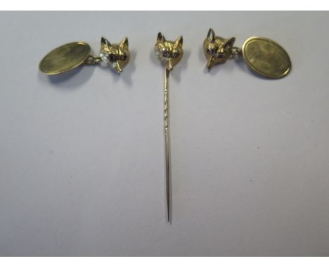 A 9ct gold fox head stick pin with ruby eyes, weight 1.57 grams and a pair of 9ct gold fox head and oval plate chain cufflink