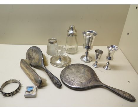 Three hallmarked silver goblets, 13cm, a worn dressing set, two worn matchstrikers, a caster and a white metal bangle and a E