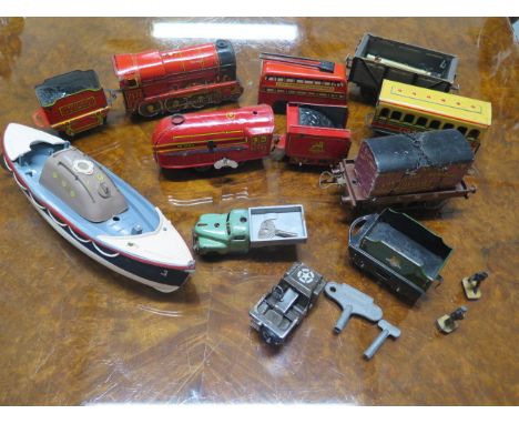 A collection of vintage pressed steel Hornby clockwork 00 gauge engines and carriages, playworn condition and other tinplate 