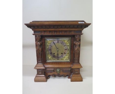 A walnut figural striking mantle clock, 40cm x 36cm, with key in running order 