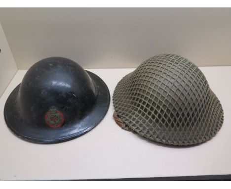 A British Army helmet and net WWII dated 1939 liner 1938 and a National Fire Service helmet dated 1943 