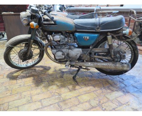 A Honda 175cc 1973 vintage motorcycle, reg PKL 22M, in need of restoration with vehicle registration document, manual and oth