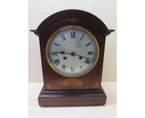 An 8 day silvered dial bracket clock mahogany case with boxwood and shell inlay, brass feet and handles to side, 38cm tall, s