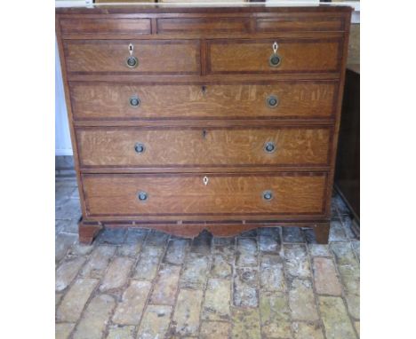 A Georgian oak and mahogany five drawer chest on bracket feet, in need of some restoration, 108cm tall x 117cm x 53cm 