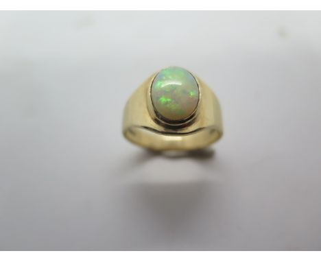 A 9ct yellow gold oval opal ring, oval approx 10mm x 8mm, ring size R, in good condition and opal alive with colour 