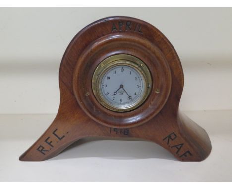 A propeller boss mantle clock carved 'April 1918 R.F.C R.A.F' with a Smiths movement, working, 28cm tall x 43cm wide 