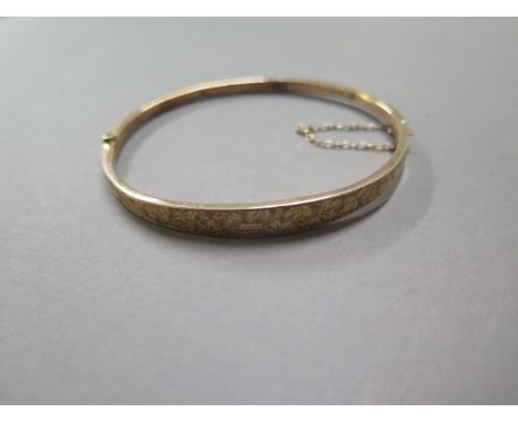 A 9ct yellow gold hollow bangle approx 4.4 grams, some denting but clasp good 