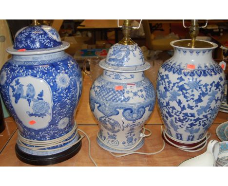A large reproduction Chinese style blue and white table lamp, h.50cm (excluding fittings); together with two others (3)