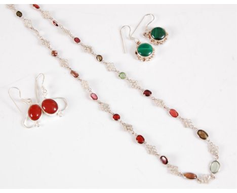 A silver and gemstone necklace, comprised of graduated collet set gemstones to include garnet, peridot smokey quartz, prasiol