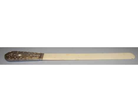 An Edwardian ivory page turned having a silver handle with embossed decoration