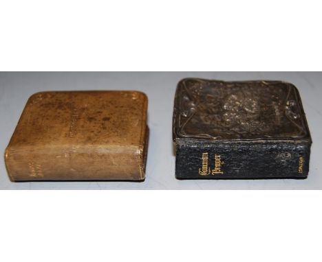 An early 20th century silver mounted miniature Book of Common Prayer, circa 1910, the cover relief decorated with putti, toge