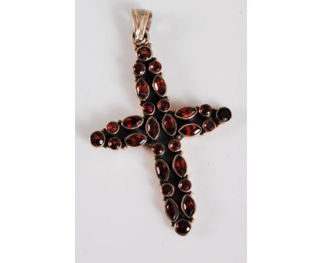 A silver and garnet cross pendant, with a mix of round and marquise cut garnets, all collet mounted with a closed back stampe
