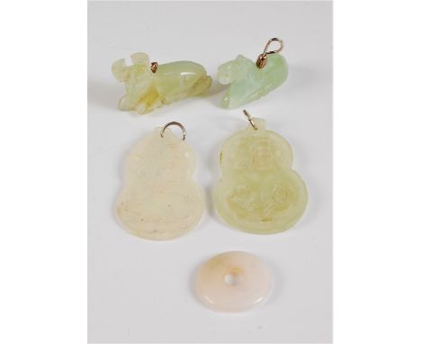 Five jade carvings, to include to jade panels one with a rabbit the other with a rat, 55mm long, a carved bison and a carved 