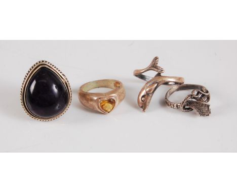 A large pear shaped amethyst cabochon ring, 28mm long, size N, a heart shaped citrine ring, size M, together with a dolphin r
