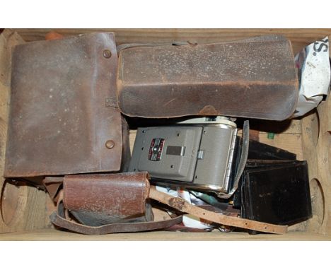A box of various vintage cameras and accessories