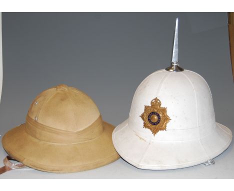 A white cloth covered pith helmet, with associated steel pike, bearing badge for the Royal Marines Amphibious Light Infantry;