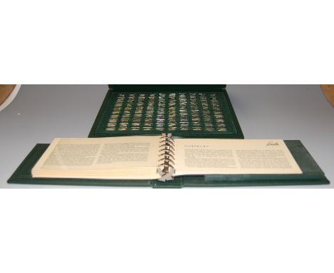 A John Pinches Ltd collection of The 100 Greatest Cars silver miniature ingot collection, in green leather case with matching
