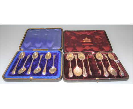 A cased set of six circa 1900 silver teaspoons with matching sugar tongs having shell shaped bowl with further shaped termina