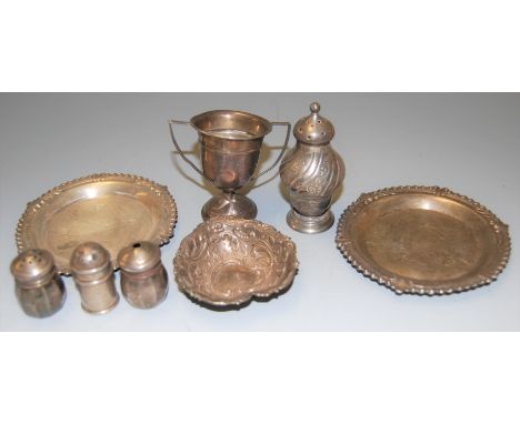 A small collection of miscellaneous silver items to include miniature twin handled trophy cup, two piece cruet, heart shaped 