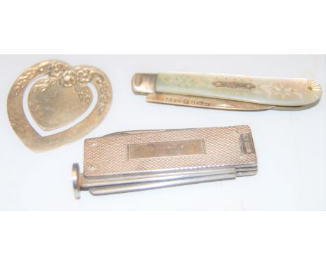 A Victorian fruit knife having a folding silver blade and mother of pearl handles, together with one other engine turned silv