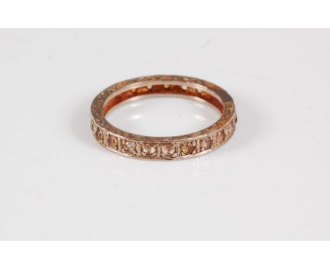 A 14ct white hardstone eternity ring, the full hoop set with small white hardstones and indistinctly stamped '585', size M, (