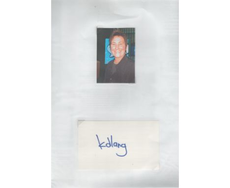 K D Lang signed 6x2inch album page. Good condition. All autographs are genuine hand signed and come with a Certificate of Aut