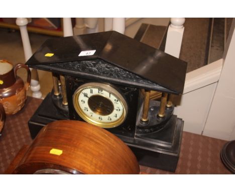 A Victorian black slate two hole mantel clock 