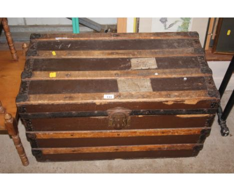 A metal and wooden bound travelling trunk