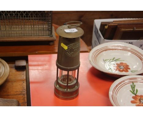 A brass cased miners lamp