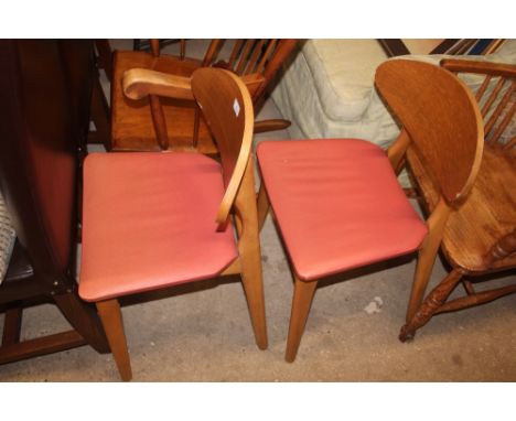 A pair of light oak veneered bar back chairs