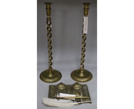 A pair of brass open twist candlesticks and an embossed brass inkwell