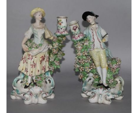A pair of Derby candlestick figures of flower sellers, c.1770, pad marks, losses