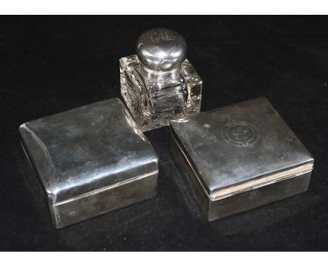 Two silver cigarette boxes and a silver mounted glass inkwell.