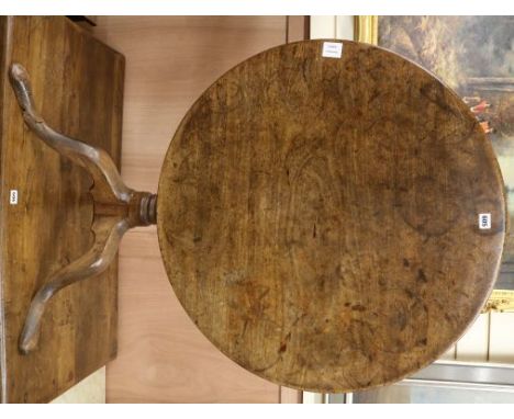 A George III mahogany circular tilt top tea table, on turned pillar and tripod cabriole base, W.86cm