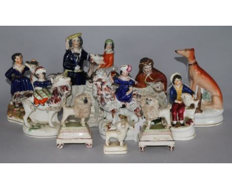 A pair of small Staffordshire poodles, six other Staffordshire figures, a flatback and an inkwell (faults)