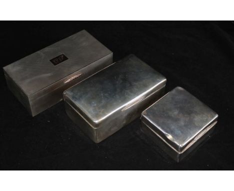 A 1950's engine turned silver cigarette box with gold thumbpiece and two other silver cigarette boxes.