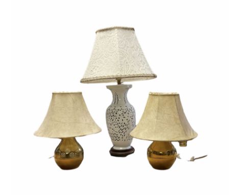  Blanc de Chine ceramic table lamp having a pierced body with lattice work decoration upon a wooden base, together with a pai