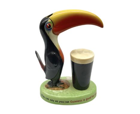 Carltonware Guinness advertising table lamp (lacking fitting) in the form of a toucan with a glass of Guinness, the base depi