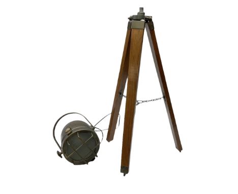 Reproduction metal spot light/lamp upon a wooden three leg tripod base, H102cm