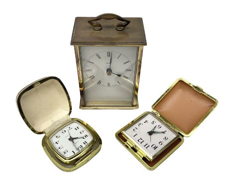 Two travelling alarm clocks with leather effect cases to include a Europa example, together with a Metamec battery operated c