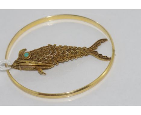 Silver gilt articulated fish pendant together with a gold plated bangle