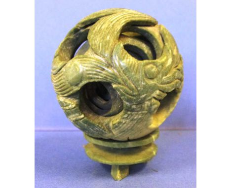 Chinese carved green stone puzzle ball on stand 12cm high approx