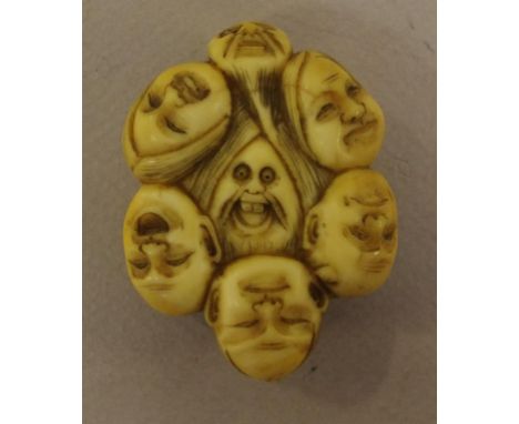 Vintage carved bone "faces"netsuke