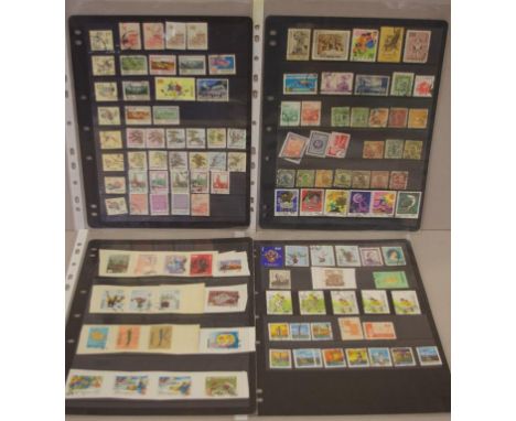 Four pages of vintage Chinese stamps