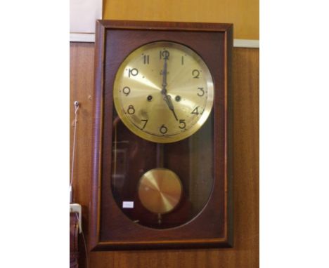 German Emes 1950s wall clock with striking movement, key and pendulum included, 45cm high, 28cm wide