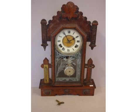 Antique Waterbury mantle clock with 8 day striking movement, key and pendulum included, 55cm high