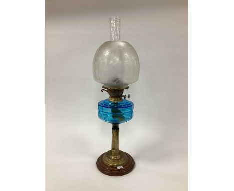 Oil Lamp Circa Early XX Century, with brass support to blue glass well, frosted glass shade.