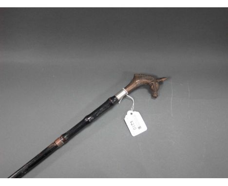An Early XX Century Swordstick, with ebonised bamboo style handle and sheath with horsehead finial, 84.5cm long.General wear 