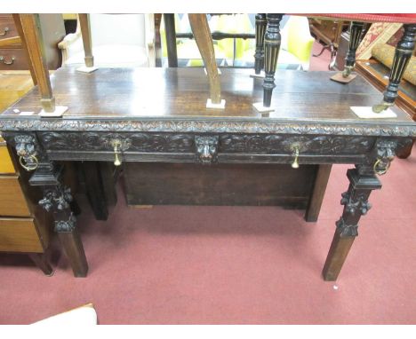 XIX Century Carved Oak Side Table, with two small carved drawers, foliage decoration, carved lion heads with brass rings, and