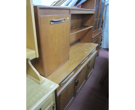 G Plan Teak Lounge Unit, circa 1970s with glass shelf to open back, lipped shaped handles to left fall front, three lower dra